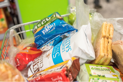 A supermarket trolley filled with groceries.